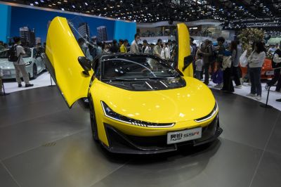Yellow sports car with butterfly doors and sleek aerodynamic front
