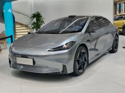 Sleek silver electric sedan with aerodynamic body and futuristic headlights