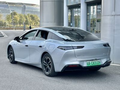 Rear-side profile with sleek taillights and aerodynamic sedan shape