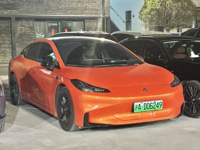 Sleek electric sedan with aerodynamic front and black alloy wheels