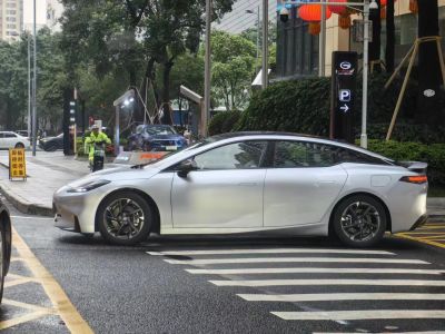 Sleek electric sedan side profile with aerodynamic shape and alloy wheels