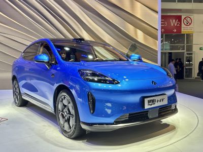 Front view of blue electric SUV with aerodynamic shape and LED headlights
