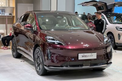 Sleek electric crossover SUV with distinctive LED headlights and smooth aerodynamic shape