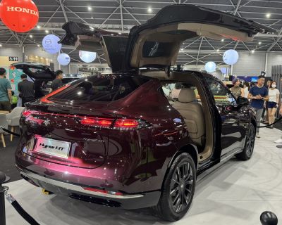 Luxury SUV with falcon wing doors and sleek rear design