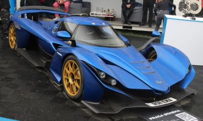 Blue aerodynamic hypercar with gold wheels and aggressive front design