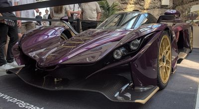 Aerodynamic front with dual headlights and carbon fiber splitter.