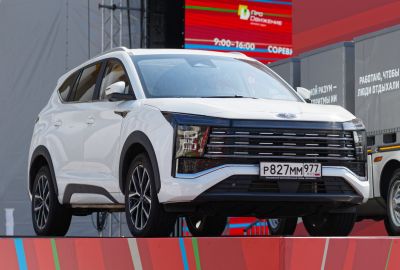 Front view of a modern white SUV with distinctive headlights and grille.