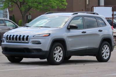 Silver SUV with unique front grille and roof rails