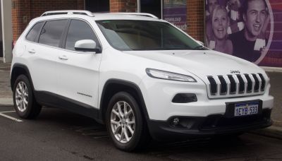 Front side profile with seven-slot grill and unique headlights