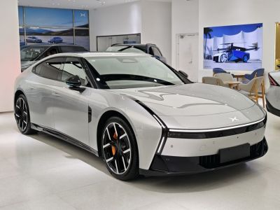 Sleek electric sedan with distinctive LED light and aerodynamic body.
