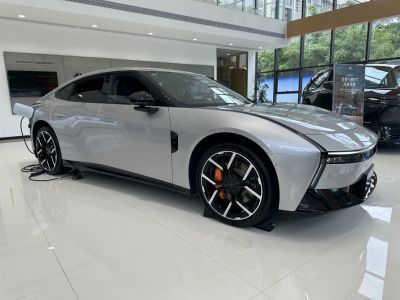 Electric sedan with aerodynamic design and charging cable.