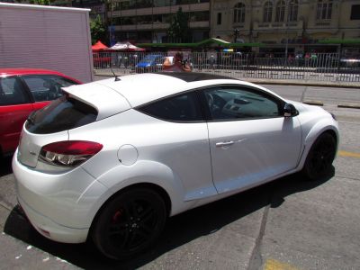 White coupe with black roof, rear spoiler, and black wheels