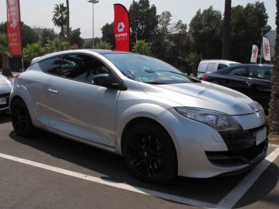 Silver coupe with black alloy wheels in side view