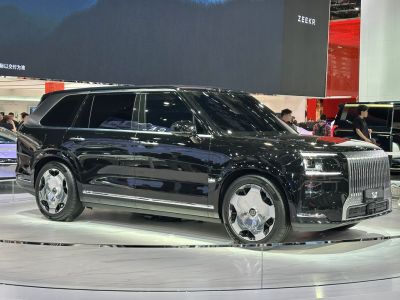Large vertical grille and futuristic aerodynamic wheels on sleek SUV