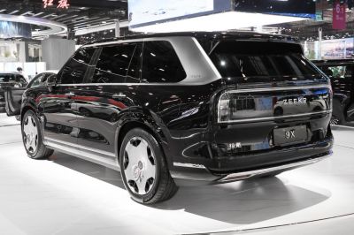 Rear and side view of a sleek black SUV with futuristic rear lighting