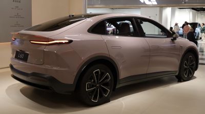 Rear and side profile of a sleek electric SUV with aerodynamic design and integrated rear spoiler