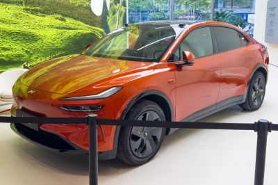 Orange modern SUV with sleek LED headlights and aerodynamic styling