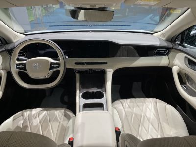 Luxury car interior with digital dashboard and beige leather seats