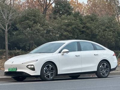 Sleek white electric sedan with aerodynamic side profile and modern headlights