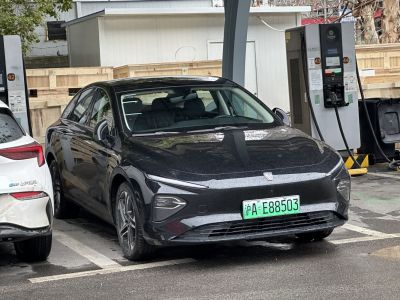 Front view of electric sedan with sharp LED headlights and aerodynamic styling