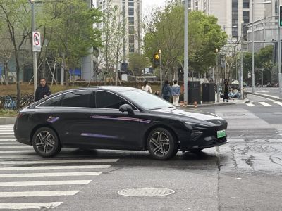 Aerodynamic black sedan with sleek profile and alloy wheels