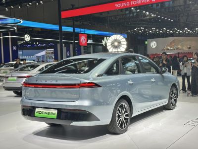 Sleek sedan rear with full-width LED light bar and alloy wheels