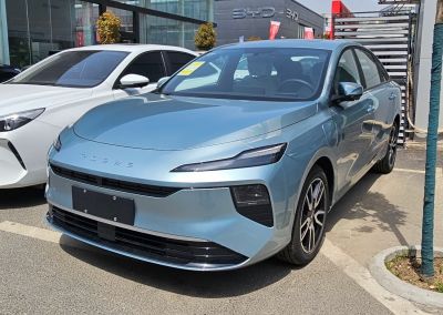 Front view of electric sedan with slim LED headlights and aerodynamic shape