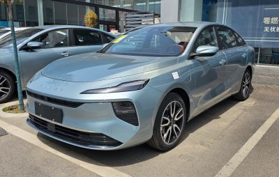 Front view of modern sedan with sleek LED headlights and aerodynamic design