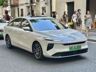 Sleek modern sedan front with advanced LED headlights and tinted windows