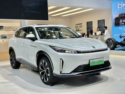 Sleek slim LED headlights and aerodynamic front design of a white SUV