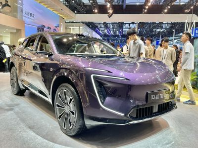 Front angled view of a sleek purple electric SUV with modern headlights