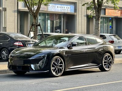 Black electric sedan with angular headlights and distinctive alloy wheels