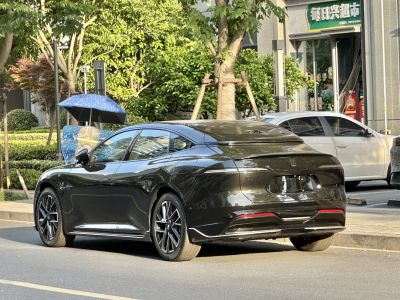 Sleek electric sedan rear with smooth lines and alloy wheels