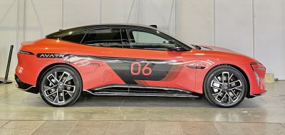 Side profile of a sleek electric sports sedan with aerodynamic alloy wheels