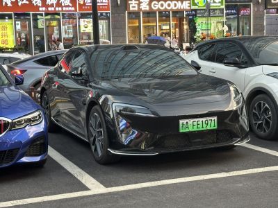 Front view of sleek electric vehicle with futuristic headlights and aerodynamic design