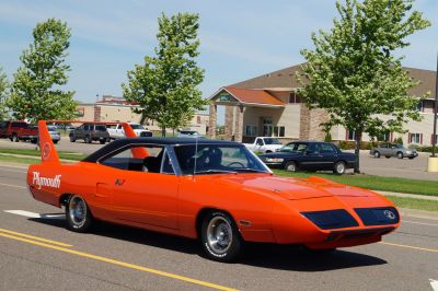 Bright orange muscle car with tall rear wing and aerodynamic nose