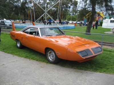Tall rear wing and aerodynamic pointed nose cone on classic muscle car