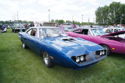 Muscle car with aerodynamic nose and tall rear wing spoiler