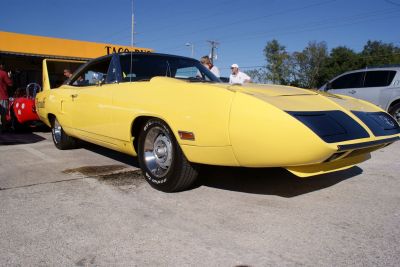Yellow muscle car with aerodynamic front nose and prominent rear wing