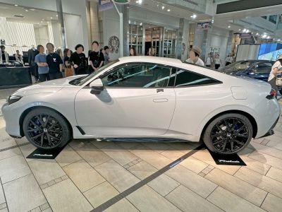 Sleek white sports coupe with aerodynamic shape and black multi-spoke alloys