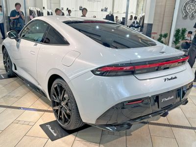 Sleek rear and side view of a white sports coupe with black wheels