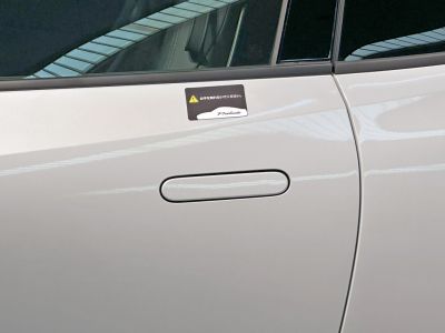 Close-up of a sleek flush door handle with a Prelude badge on a car door