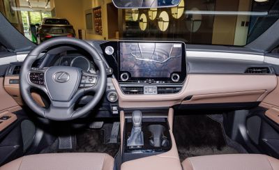 Modern steering wheel, large touchscreen, beige and black dashboard