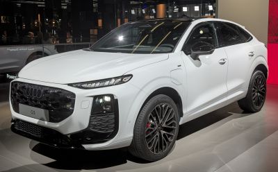 Front view of modern SUV with LED headlights and black honeycomb grille