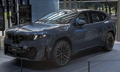 Electric SUV with kidney grille, sleek LED headlights, and multi-spoke alloy wheels