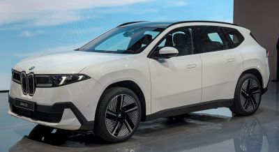 Electric SUV with futuristic headlights and distinctive wheel design