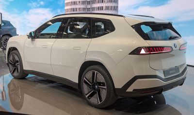 Rear view of electric SUV with sharp taillights and aerodynamic alloy wheels