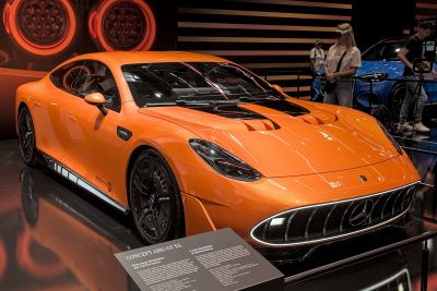 Orange sports coupe with black accents and aggressive grille