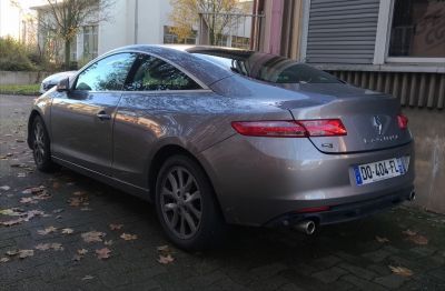 Rear view of a sleek coupe with dual exhausts and LED taillights