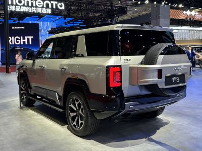 Rear three-quarter view of an SUV with spare tire and modern taillights